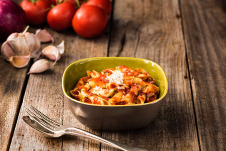 Penne Pasta with Chorizo Creamy Tomato Sauce on Rustic Table Topの写真素材
