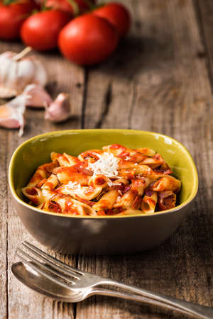 Penne Pasta with Chorizo Creamy Tomato Sauce on Rustic Table Topの写真素材