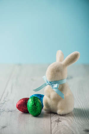 Easter eggs and a bunny on a white tableの写真素材