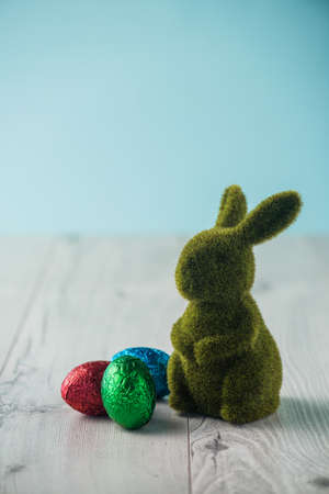 Easter eggs and a bunny on a white tableの写真素材