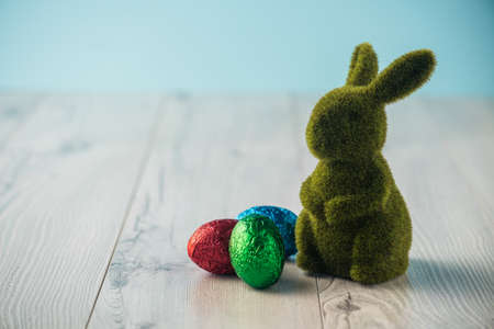 Easter eggs and a bunny on a white tableの写真素材