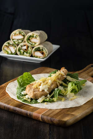 Breaded Chicken burrito Wrap With Fresh Lettuce Cheese on rustic backgroundの写真素材