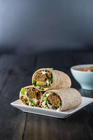 Vegetarian falafel wraps with avocado and cheeseの写真素材