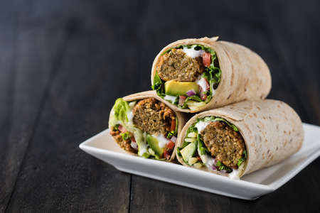 Vegetarian falafel wraps with avocado and cheeseの写真素材