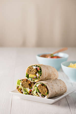 Vegetarian falafel wraps with avocado and cheeseの写真素材