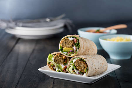Vegetarian falafel wraps with avocado and cheeseの写真素材