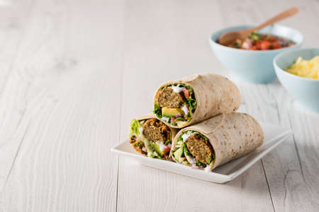 Vegetarian falafel wraps with avocado and cheeseの写真素材