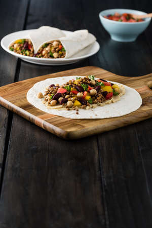 Vegan wraps with lentil, chickpea, kidney bean, peppers and hummus sauceの写真素材