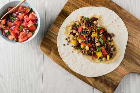 Vegan wraps with lentil, chickpea, kidney bean, peppers and hummus sauceの写真素材