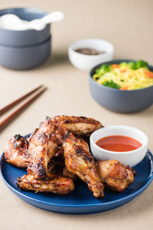 Barbecue chicken wings serves noodles with hot dipping sauceの写真素材