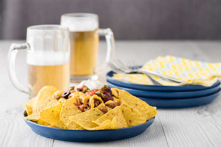 Beef nachos with beers on rustic backgroundの写真素材