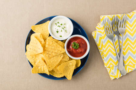 Nachos with salsa and sour cream dipsの写真素材