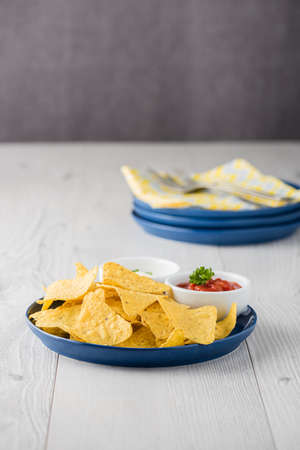 Nachos with salsa and sour cream dipsの写真素材