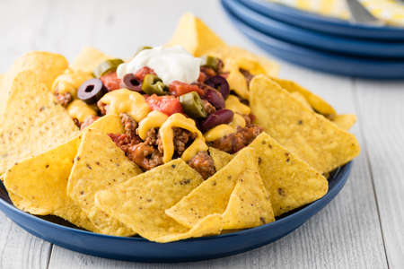 Beef nachos with  jalapeno, olives, tomato, beans cheddar cheese and sour creamの写真素材