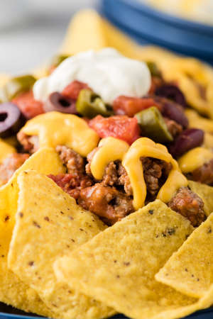 Beef nachos with  jalapeno, olives, tomato, beans cheddar cheese and sour creamの写真素材