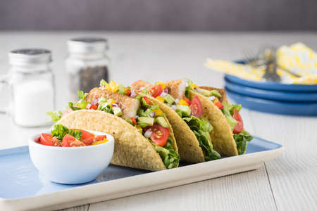 Fish tacos shell with tomato, beans, capsicum and avocado salsaの写真素材