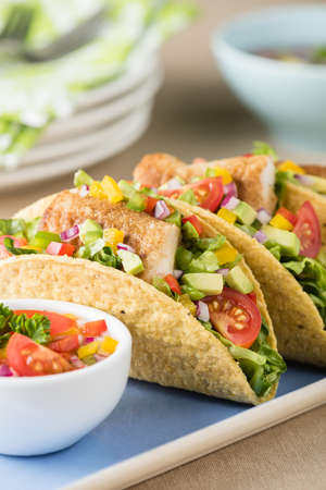 Fish tacos shell with tomato, beans, capsicum and avocado salsaの写真素材