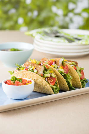 Fish tacos shell with tomato, beans, capsicum and avocado salsaの写真素材
