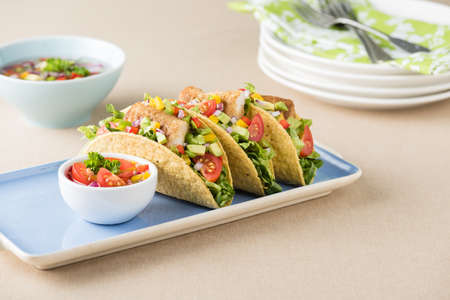 Fish tacos shell with tomato, beans, capsicum and avocado salsaの写真素材