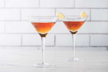 Fresh home made Manhattan cocktails with lemon and maraschino cherryの写真素材