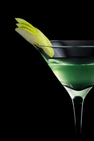 Apple Martini cocktail with garnish on black backgroundの写真素材