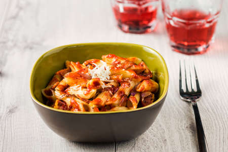 Penne Pasta with Chorizo Creamy Tomato Sauce on White Table Topの写真素材
