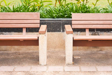bench on the sidewalk in the parkの写真素材