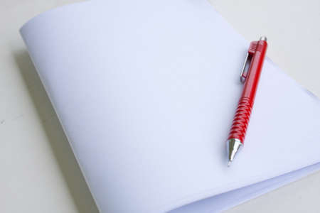 blank note and the pencil on the deskの写真素材