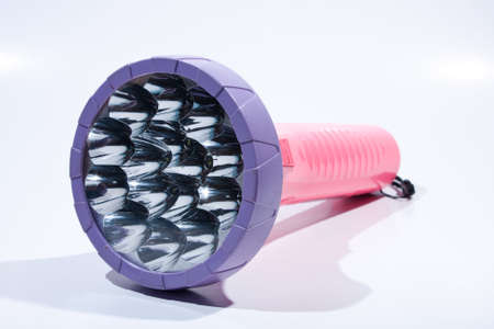 Flashlight on white background. Placed on a colorful background. The dark night for two.