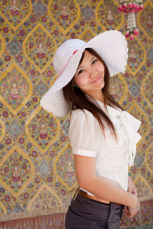 smiling young thai girl on the thai paint backgroundの写真素材