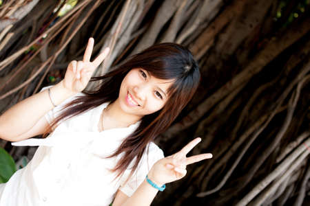 smiling young thai girl and white hat in travel.の写真素材