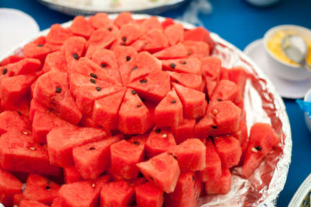 Sliced red juicy watermelon served on a big plateの写真素材