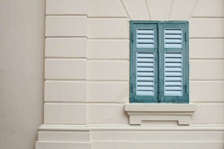 Classic green window on a wall of a building. の写真素材