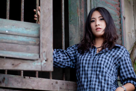 portrait asian girl in the wood wall.beauty portrait girl.の写真素材