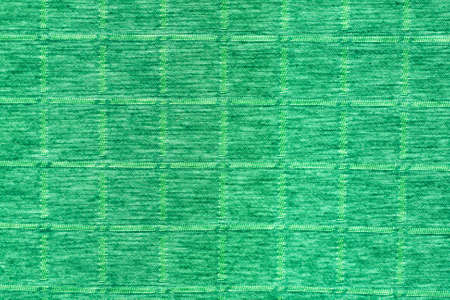 Textured fabric in green and has a square ground.