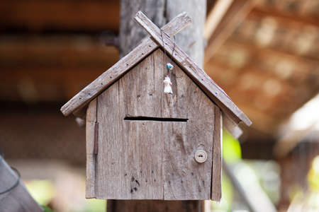 Mailbox is made of wood carved into shapes
