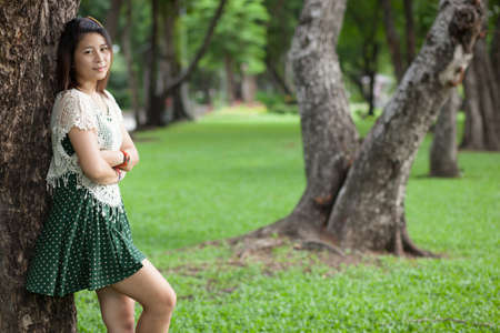portrait cute girl in park.black hair cute girl in parkの写真素材
