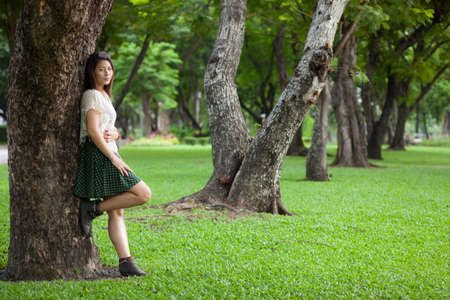 portrait cute girl in park.black hair cute girl in parkの写真素材