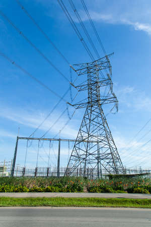 High voltage towers. The meadow below. Industry and nature coexist in appropriate Slightly cloudy...