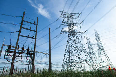High voltage towers. The meadow below. Industry and nature coexist in appropriate Slightly cloudy...