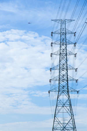 High voltage towers. The meadow below. Industry and nature coexist in appropriate Slightly cloudy...