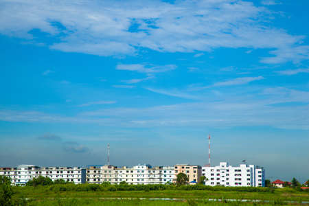 Condos and prairie sky with little clouds. Residential buildings to increase the volume.の写真素材