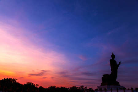 Buddha in the evening sky with the colors of red and blue in the near dusk.の写真素材