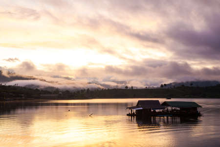 Raft in the river. Mountains covered with fog in the morning.の写真素材