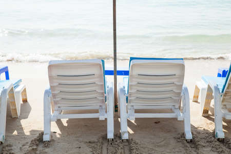 Benches and umbrellas. On the sandy beach lot. To serve tourists.の写真素材