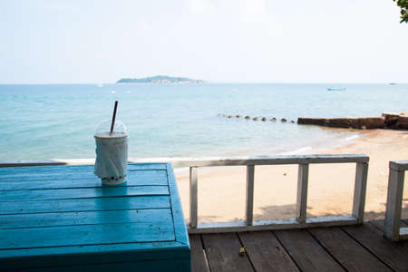 Coffee cup on the table. Beachfront restaurants at the beach.の写真素材