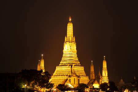 Wat Arun at night. The pagoda is a light yellow-orange.の写真素材