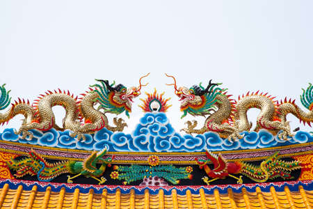 Dragon statue roof. Dragon sculpture on the roof of the two colors. Behind the scenes of white.の写真素材