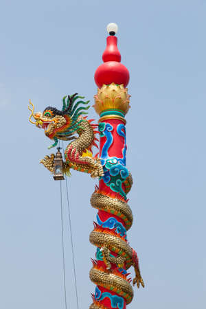 Pillar statue of a dragon. Red dragon Pillar statues rising from the ground.の写真素材