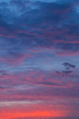 Clouds at sunset. The light of the sun and at night.の写真素材